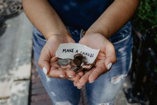 Woman holding coins in hands.